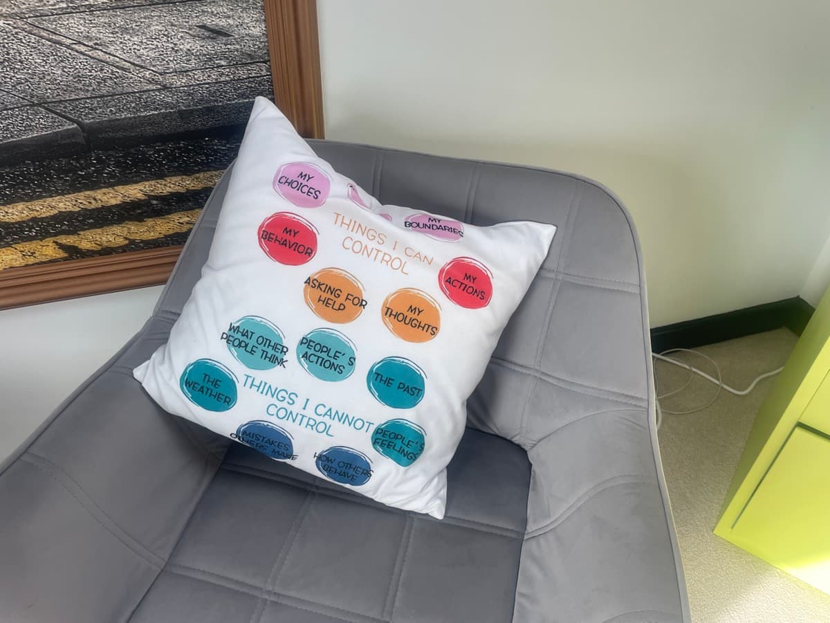Detail of the therapy room - Things I Can Control cushion in a cosy setting